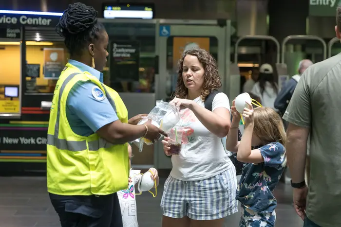 MTA employee gives out masks at the Fulton Street subway station amid hazy conditions due to smoke from the Canadian wildfires on June 8, 2023